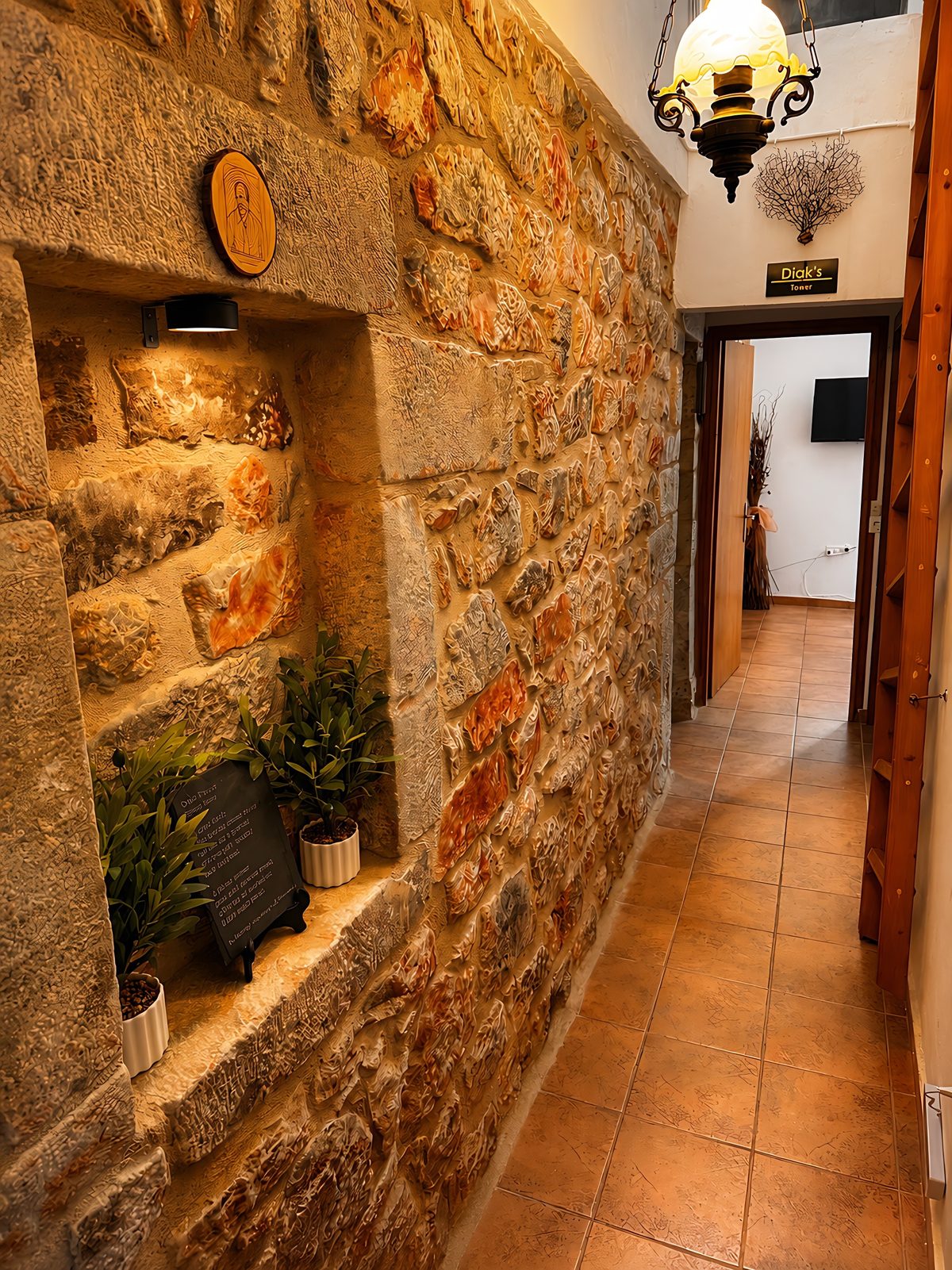 Inside Diak's Tower, warm stone corridor with a traditional lamp